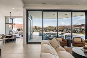 Living room featuring expansive windows, a mountain view, recessed lighting, and light tile patterned flooring