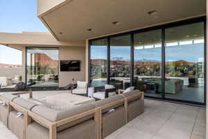 Living room featuring floor to ceiling windows and light tile patterned flooring