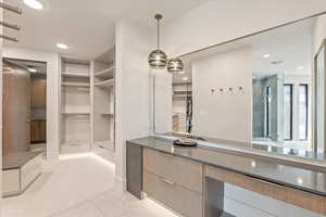 Full bath with a spacious closet, recessed lighting, and vanity