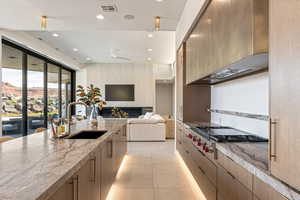 Kitchen featuring open floor plan, stainless steel gas stovetop, modern cabinets, recessed lighting, and ceiling fan