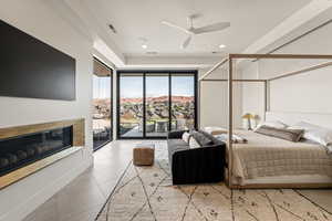 Bedroom featuring light tile patterned floors, a fireplace, access to outside, a ceiling fan, and recessed lighting