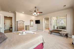 Bedroom with carpet, arched walkways, and a ceiling fan