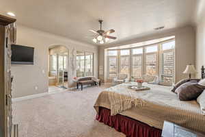 Bedroom with a ceiling fan and carpet