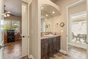 Bathroom with vanity, healthy amount of natural light, ceiling fan, and recessed lighting