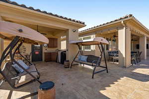 View of patio featuring outdoor dining space and a ceiling fan