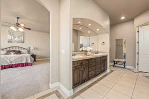 Bathroom featuring inlaid floor details, ensuite bath, light tile patterned flooring, double vanity, and recessed lighting
