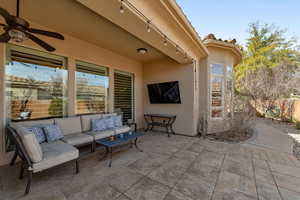 View of patio featuring a ceiling fan and outdoor lounge area