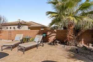 Fenced backyard with a patio