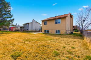 Rear view of house with a fenced backyard