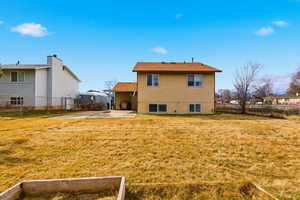 Rear view of house featuring a fenced backyard and a patio area