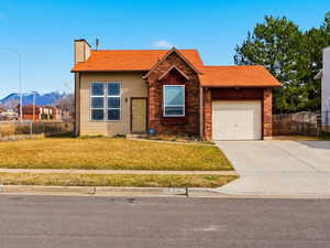 View of front facade with concrete driveway, a shingled roof, a mountain view, an attached garage, RV parking, and a chimney