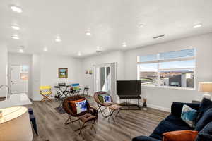 Living area featuring wood finished floors, recessed lighting, and healthy amount of natural light