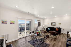 Living area with wood finished floors and recessed lighting