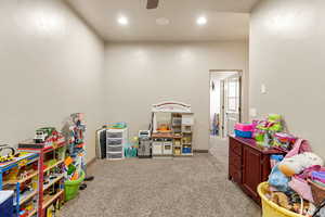 Recreation room with light colored carpet, ceiling fan, and recessed lighting