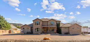View of front of property with stone siding and covered porch