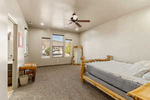 Bedroom with light colored carpet, a ceiling fan, and recessed lighting