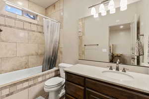 Full bathroom with vanity and tiled shower / bath combo