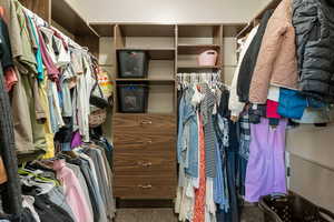 Walk in closet featuring dark carpet
