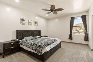 Bedroom with light carpet, recessed lighting, and a ceiling fan