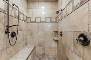 Full bath featuring tiled shower