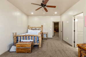 Carpeted bedroom with recessed lighting and a ceiling fan