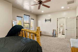 Bedroom with light carpet, a ceiling fan, recessed lighting, and connected bathroom
