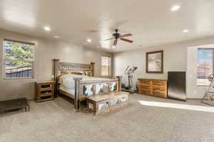 Bedroom featuring light colored carpet, ceiling fan, and recessed lighting