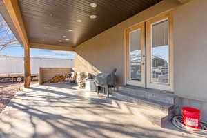 View of patio with french doors, entry steps, and area for grilling