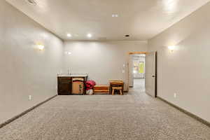 Misc room featuring carpet and baseboards
