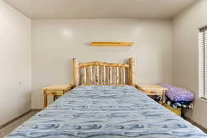 Carpeted bedroom featuring baseboards