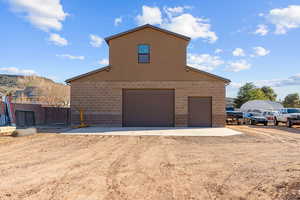 View of property exterior with a garage and brick siding