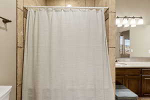 Full bath with vanity and a shower with curtain