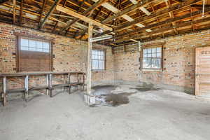 Misc room featuring brick wall