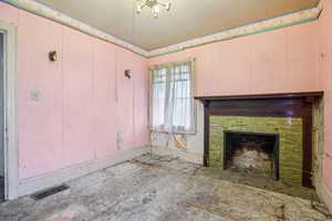 Unfurnished living room with baseboards and a fireplace