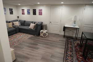 Living area with wood finished floors and recessed lighting