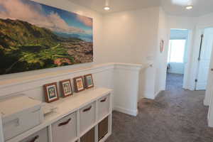 Hallway featuring dark carpet and recessed lighting