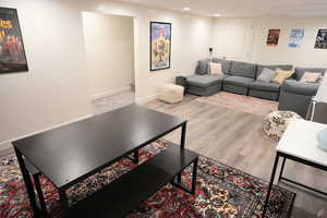 Living area featuring light wood-style flooring and recessed lighting