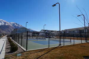 View of tennis court featuring a residential view