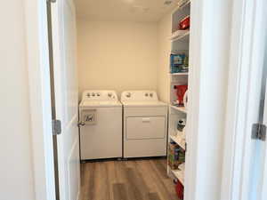 Laundry room featuring dark wood finished floors and washing machine and dryer