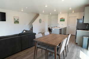 Dining area featuring light wood-type flooring and recessed lighting
