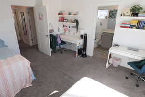 Primary Bedroom featuring a desk and carpet floors