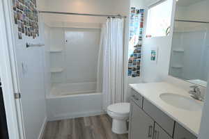 Bathroom featuring vanity, light wood-type flooring, and shower / tub combo
