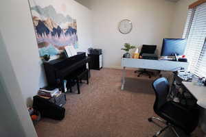 Carpeted office featuring baseboards