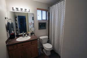 Full bathroom with vanity and curtained shower