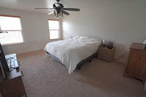 Main Bedroom featuring light colored carpet and ceiling fan