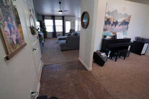 Hallway featuring dark carpet and dark tile patterned floors