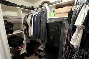 Walk in closet with carpet floors
