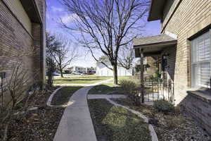 View of grassy yard with a residential view and a porch