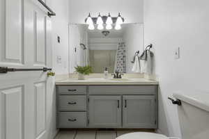 Bathroom featuring vanity, curtained shower, and light tile patterned floors