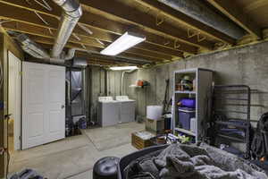 Unfinished below grade area with independent washer and dryer and heating unit